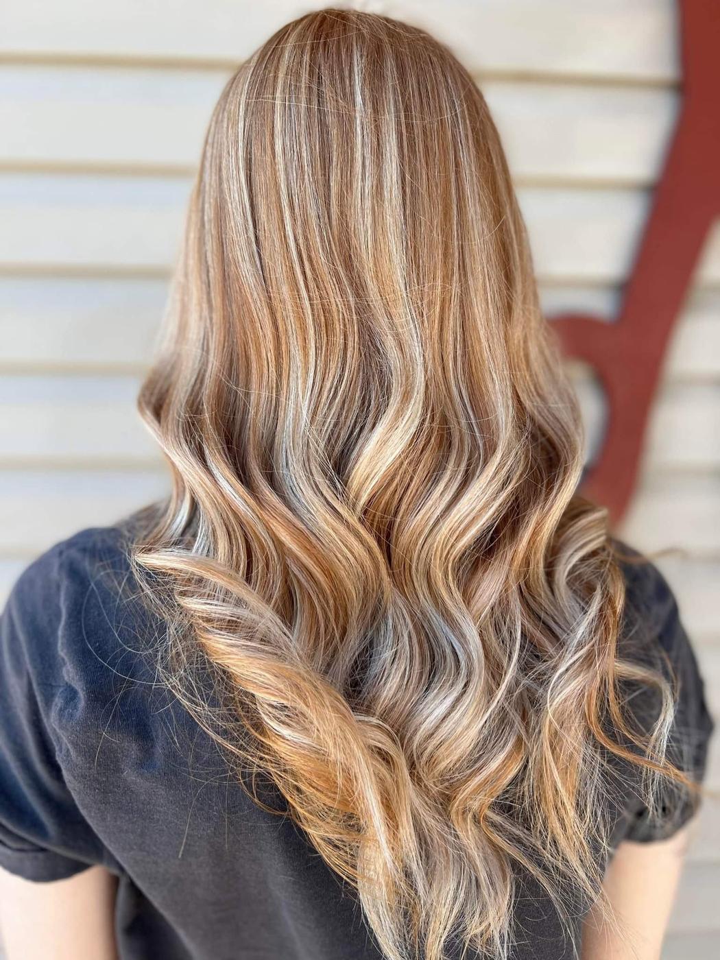 Honey blonde hair with lighter silver ribbons through the waves.